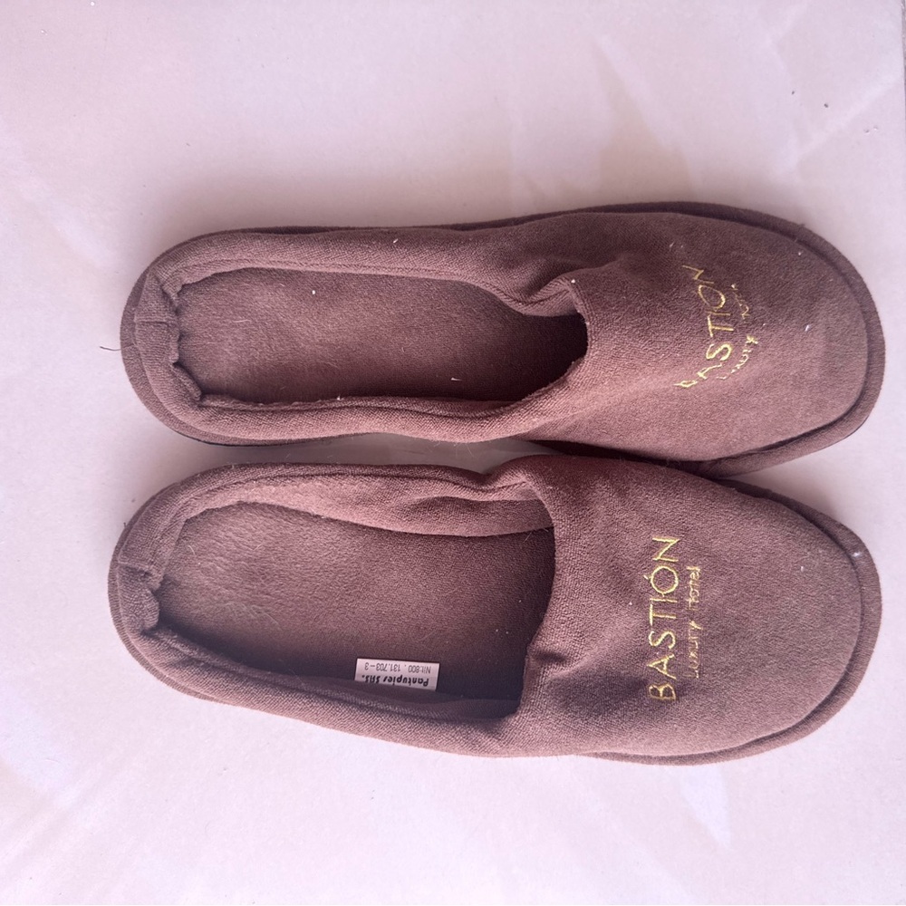 brown Bastion Luxury Hotel disposable slippers, likely made of coral velvet.